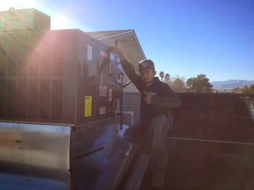 HVAC technician performing Heat Pump Repair on a rooftop unit in Jacksonville Beach